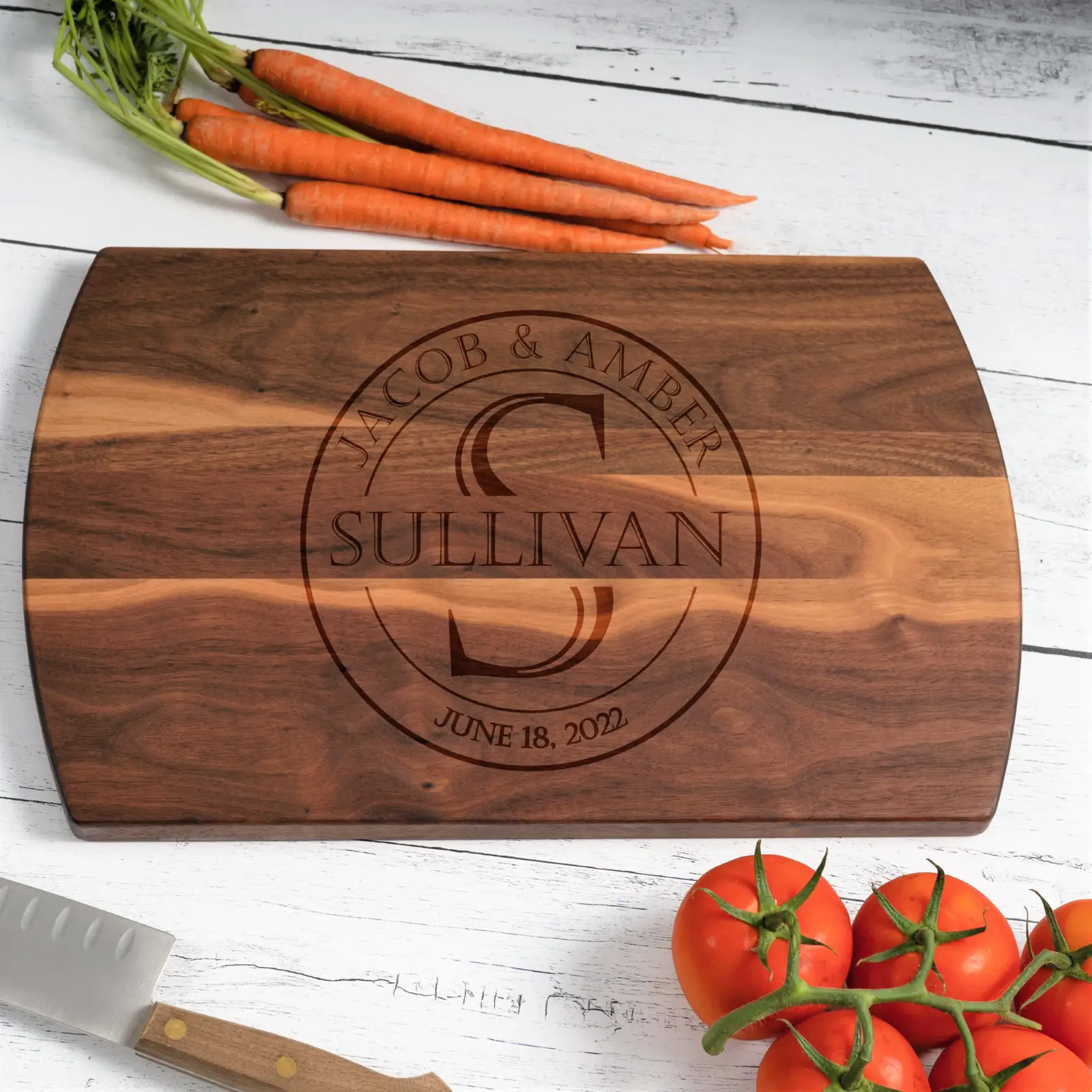 A photo of a cutting board with the names Jacob & Amber and the family's surname, Sullivan, engraved inside a large circle.